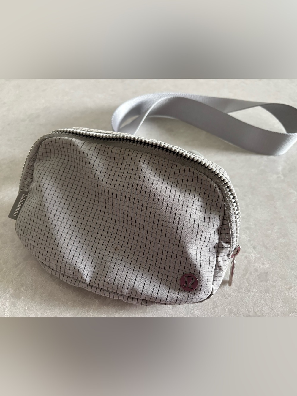 Lululemon light gray/silver color with Black Grid Crossbody Belt Bag